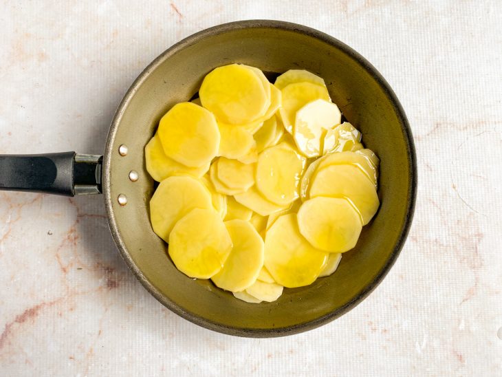 Batatas cortadas adicionadas na panela.