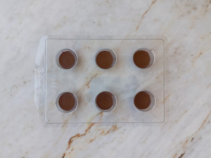 Porção de chocolate derretido colocada nas forminhas.