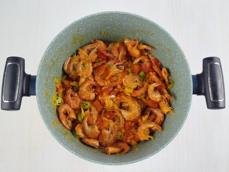 Na mesma panela, tomate picado e as pimentas-de-cheiro adicionadas, em seguida, os camarões.